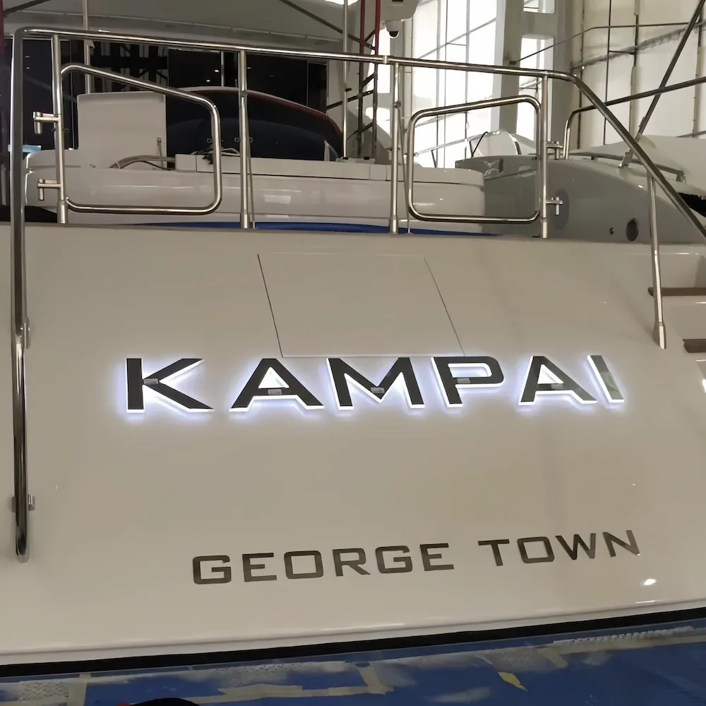 Illuminated yacht lettering with even halo diffusion for night identification.